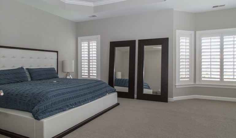 Polywood shutters in a minimalist bedroom in Chicago.